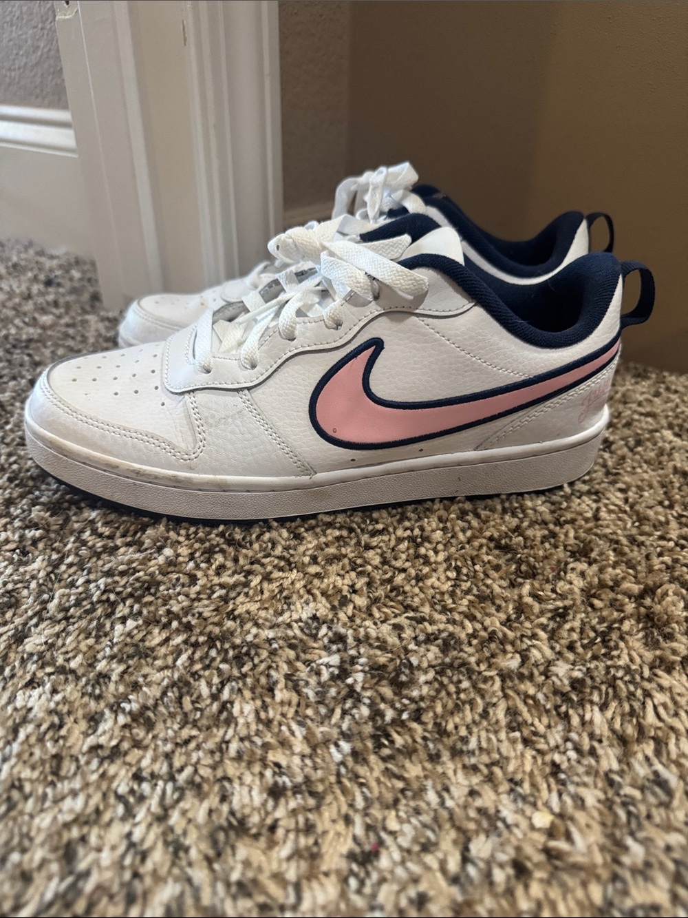 Nike White Low-Top Sneakers with Pink Swoosh and Navy Trim
